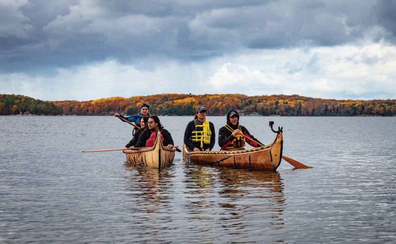 group-of-people-using-a-bark-canoe